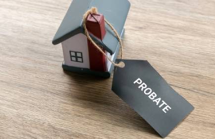 Probate Process Concept with House Model and Legal Tag for Estate Settlement